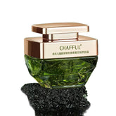 Green skincare product with rose gold cap on a natural background