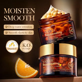 Two jars of SADÜler Rejuvenating Deep Collagen Vitamin C Capsule Cream with an orange slice on a dark background.