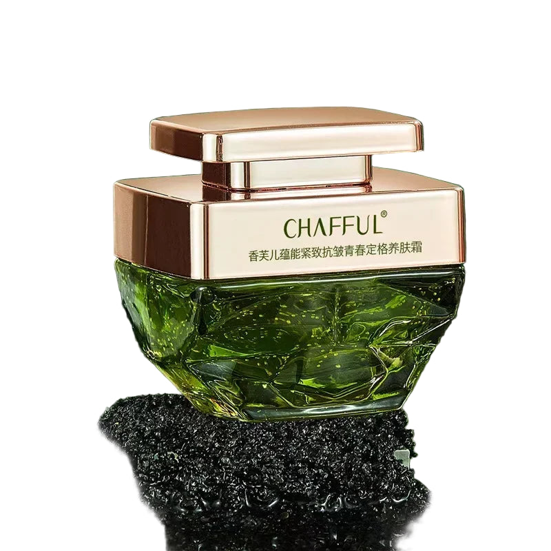 Green skincare product with rose gold cap on a natural background