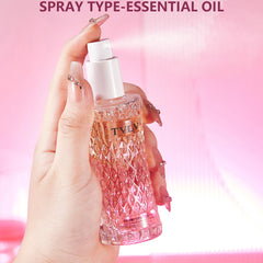 Hand holding a TVLV essential oil spray bottle against a pink background