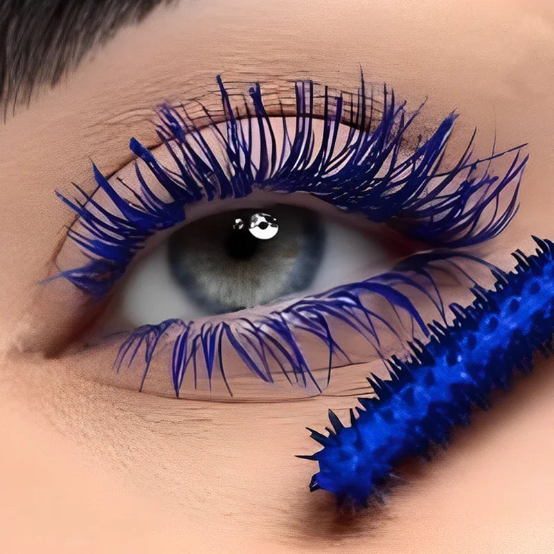 Close-up of an eye with blue eyeliner and a blue eyelash curler.