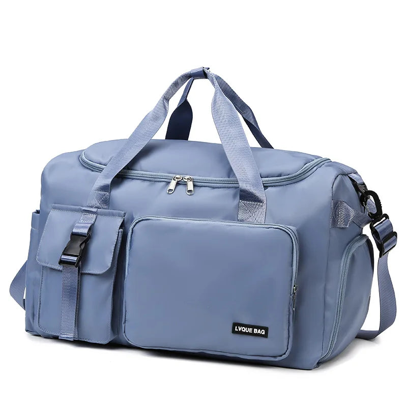 Blue duffel bag with multiple pockets and straps on a white background