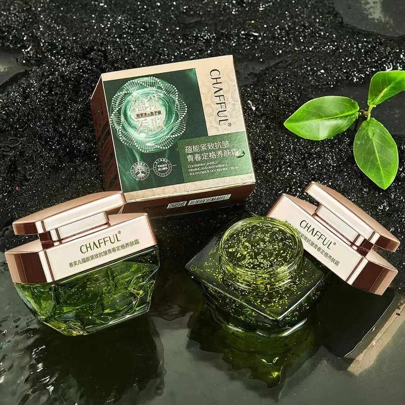 Green skincare product with packaging on a dark textured background