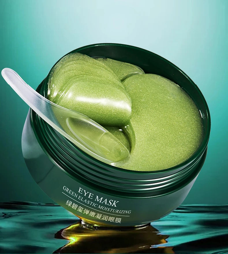 Green eye mask packaging with a spoon on a teal background
