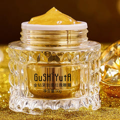 Cosmetic jar with gold cream on a glittery gold background